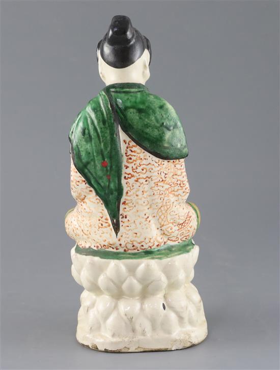 A Chinese Sancai glazed pottery seated figure of Guanyin, Qing dynasty, H.27cm, some flaking to glaze